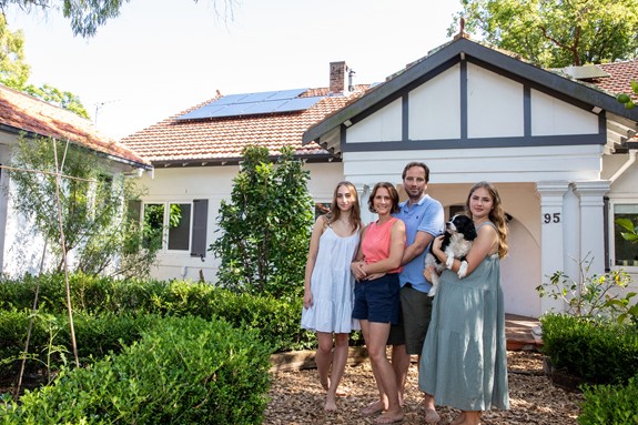 photo of qcell solar panel and battery customers, family of 4 with dog, in australia