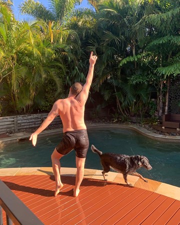 man happy by pool in australia